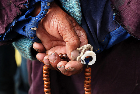 A Ladakhi man thumbs his rosary in Choglamsar, India.